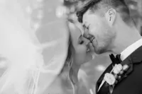 Bride and groom share a tender moment with foreheads together.