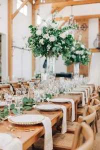 Elegant wedding reception table setting with floral centerpieces.
