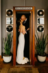 wedding couple kissing in booth