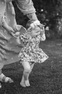 smiling little girl learning to walk