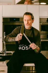 Portrait of Michael Voltaggio seated with a chef's knife between rounds