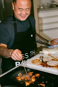 Jet Tila searing skewers on a grill pan during competition