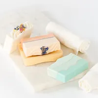 Styled product photography of artisanal soap bars photographed with soft linens and minimal props in a clean, editorial flat lay