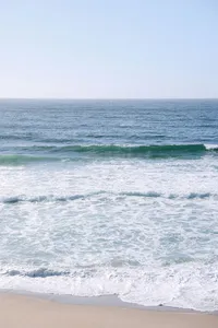 Clean wave breaking on the shore below Monterey Beach Hotel