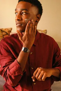 Man applying skincare product at home in warm natural light, lifestyle medical photography by Chelsea Loren for a telehealth skin and dermatology brand campaign