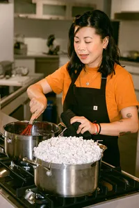 Chef Mei Lin stirring a pot of popcorn on a Bosch gas range