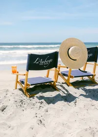 Beach front hotel in San Diego featuring chairs, aperol spritz and french straw hat
