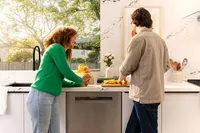 Bosch dishwasher installed in a white kitchen with marble backsplash