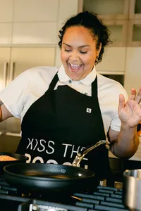 Chef Evelyn Garcia laughing at the range mid-round