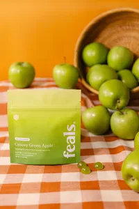 Commercial lifestyle food and beverage photography for Feals CBD gummies, featuring a styled green apple flavor product setup created for CPG website product pages, paid ads, and social media campaigns