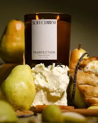 Soft Current Pearfection candle rising behind a pile of whole pears, mascarpone, puff pastry, vanilla bean, and cinnamon sticks on an olive backdrop. Food styling and candle photography by Chelsea Loren.