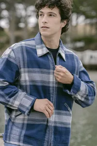 Blue and grey plaid flannel zip jacket over a black tee, apparel campaign frame