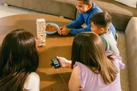 Overhead of a game night, the device and app in hand at the table