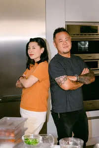 Chefs Mei Lin and Jet Tila standing back to back in the Bosch showroom kitchen