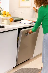 Woman closing the door of a Bosch dishwasher