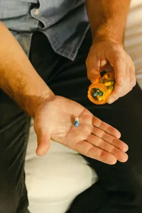 Close frame of a capsule tipped into an open palm at home