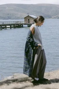 Grey knit tank and grey skirt with a plaid layer, shot at the water's edge