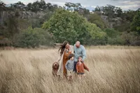 San Antonio family photography session in field of grass by the Guadalupe River