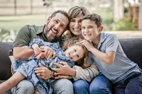 lifestyle family photo session at a client's home in New Braunfels, with family snuggling on the couch