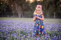 Young girl standing in a field of bluebonnets in New Braunfels