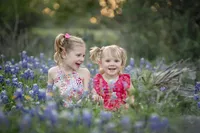 two young girls in the bluebonnets during photo session in New Braunfels
