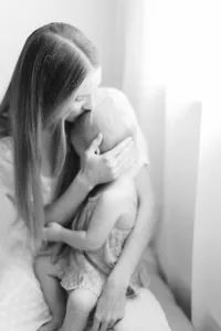 intimate black and white motherhood portrait of a mom and her baby at Kate Marie Portraiture's studio near Dallas, Texas