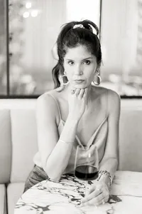 Professional headshot of a Dallas/Fort Worth business owner holding a glass of red whine as she poses for the Dallas brand photographer.