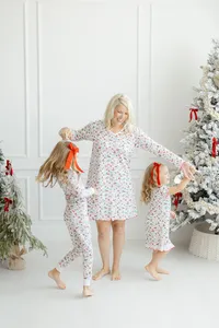 A mother dancing with her children as they are dressed in Dondolo christmas clothes.
