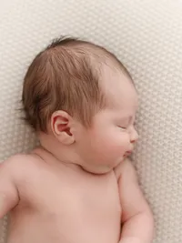Newborn baby side profile photographed in a Salem newborn photography studio.