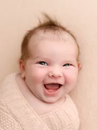 Happy baby smiling during a baby photography session in Salem, Oregon.