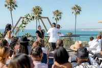 Groom hugging man at San Diego wedding