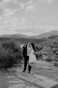 Black and white image of engaged couple smiling at the Red Rock Canyon