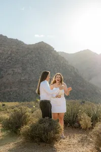 Engaged couple laughing with Nevada mountains in back