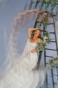 A pregnant woman holds her belly with flowers