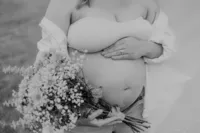 Close up of a pregnant belly with flowers
