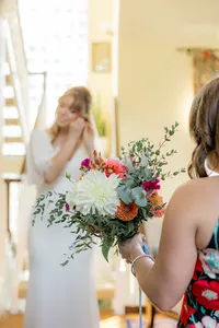 Close up of wedding bouquet with bride in the background
