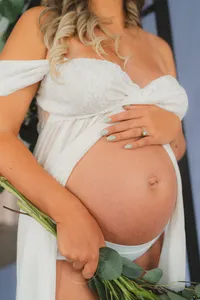 A pregnant woman holds her belly