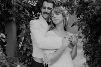 Groom holding wife from behind