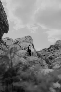 Black and white Portrait image of engaged couple on a rock at the Red Rock Canyon