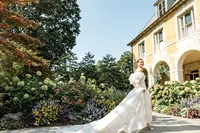 Bride picking up her dress with flowers in the back at Carniwood Estate