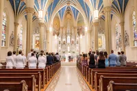 Wedding guests standing in wedding chapel