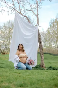 A pregnant woman is happy while holding her belly