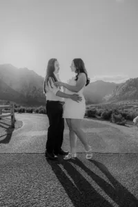 Engaged couple walking on empty road with Nevada mountains in the back