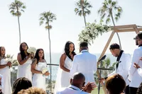 Bride and groom at the alter at their San Diego wedding with bridesmaid in the background