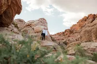 Landscape image of engaged couple on a rock at the Red Rock Canyon