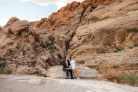 Engaged couple sitting on rock at the Red Rock Canyon smiling