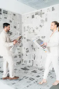 A couple walks with newspapers