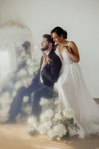 Bride and groom surrounded by flowers at The Sure Thing Chapel