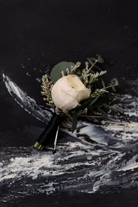 A flower sits on a black marble background
