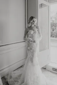 Bride looking down in a form fitting wedding dress